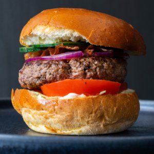 Home-made beef burgers with cheese and veggies