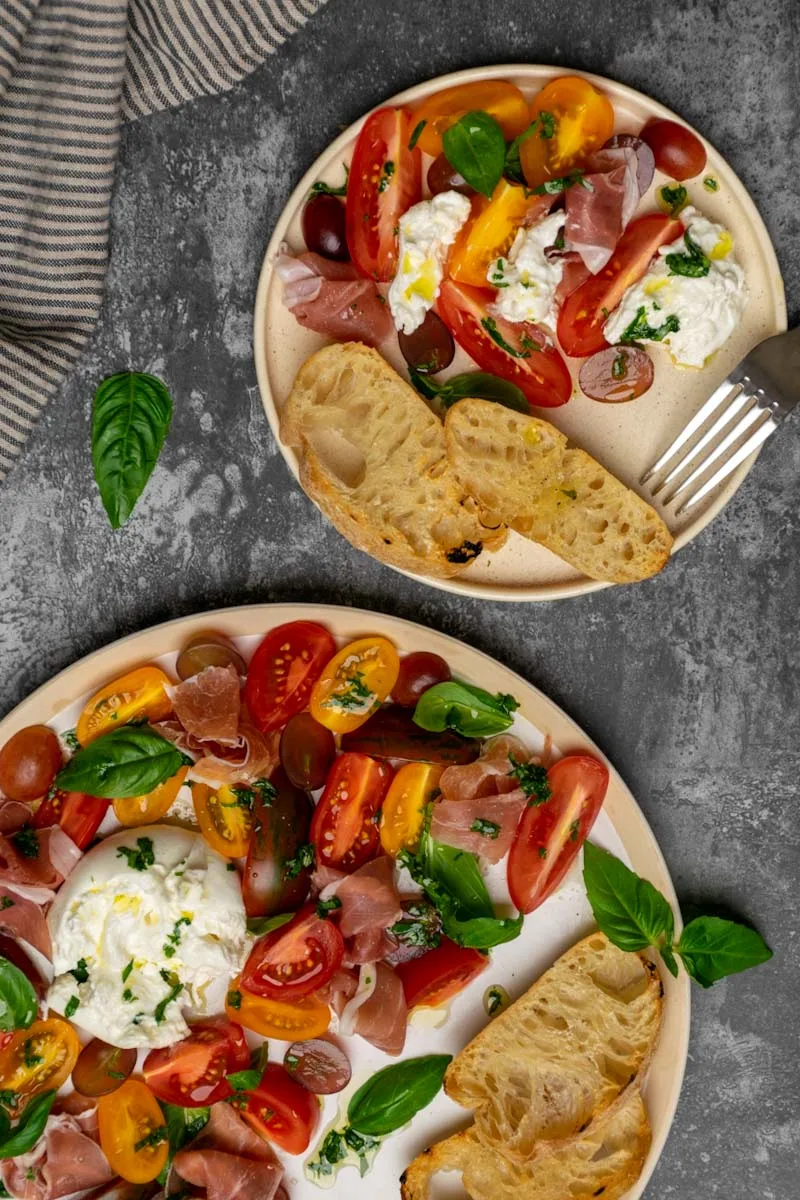 Simple tomato salad with burrata, prosciutto and ciabatta