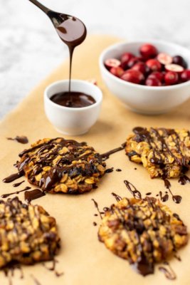 Oatmeal cookies on a paper with melted chocolate