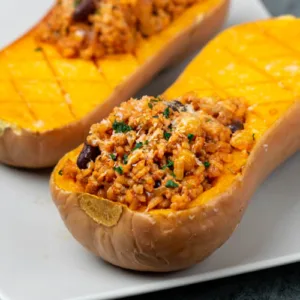 Stuffed butternut squash on a plate.