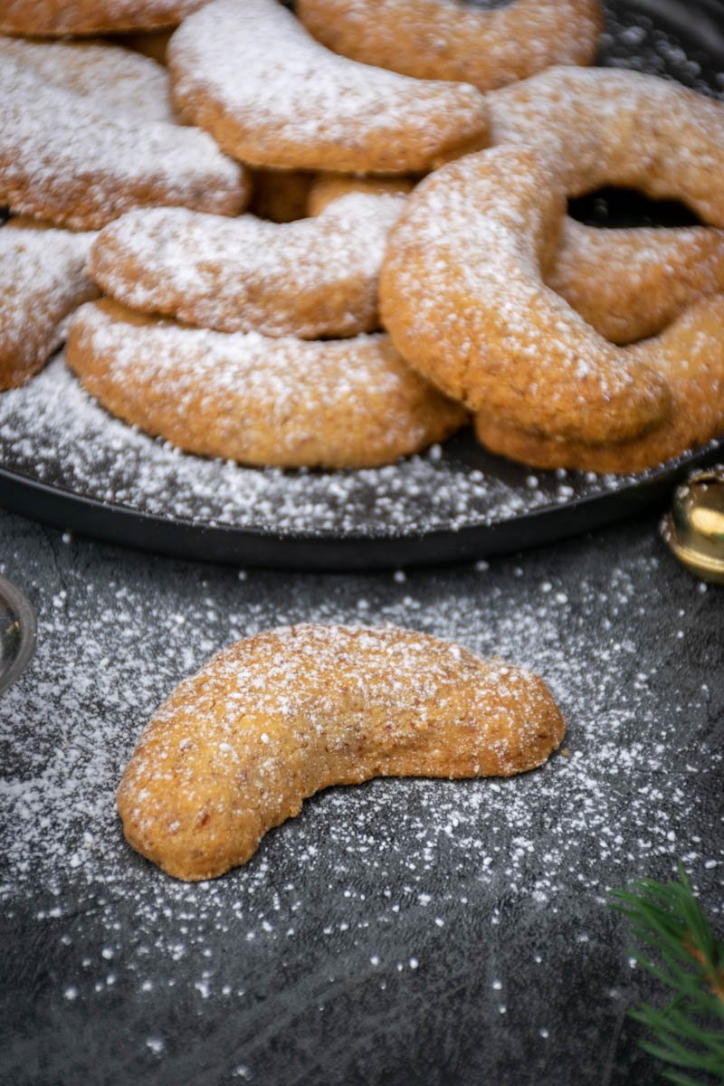 One almond crescent cookie with sugar, close up. 