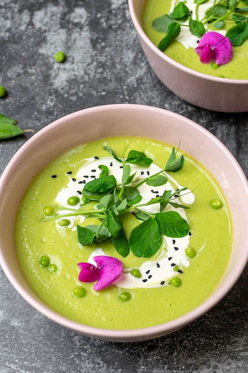 Green pea soup in two bowls, close view